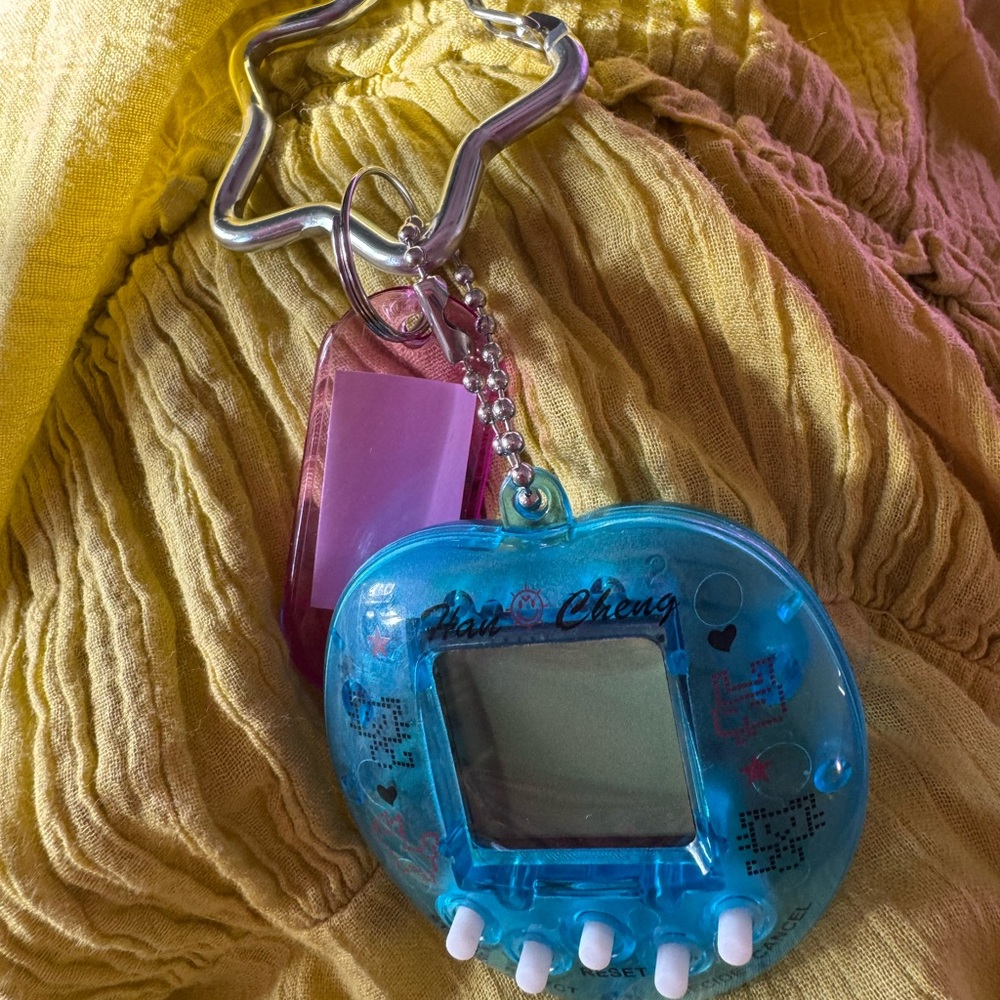 New blue mini tamagotchi toy on a silver star keychain/purse charm